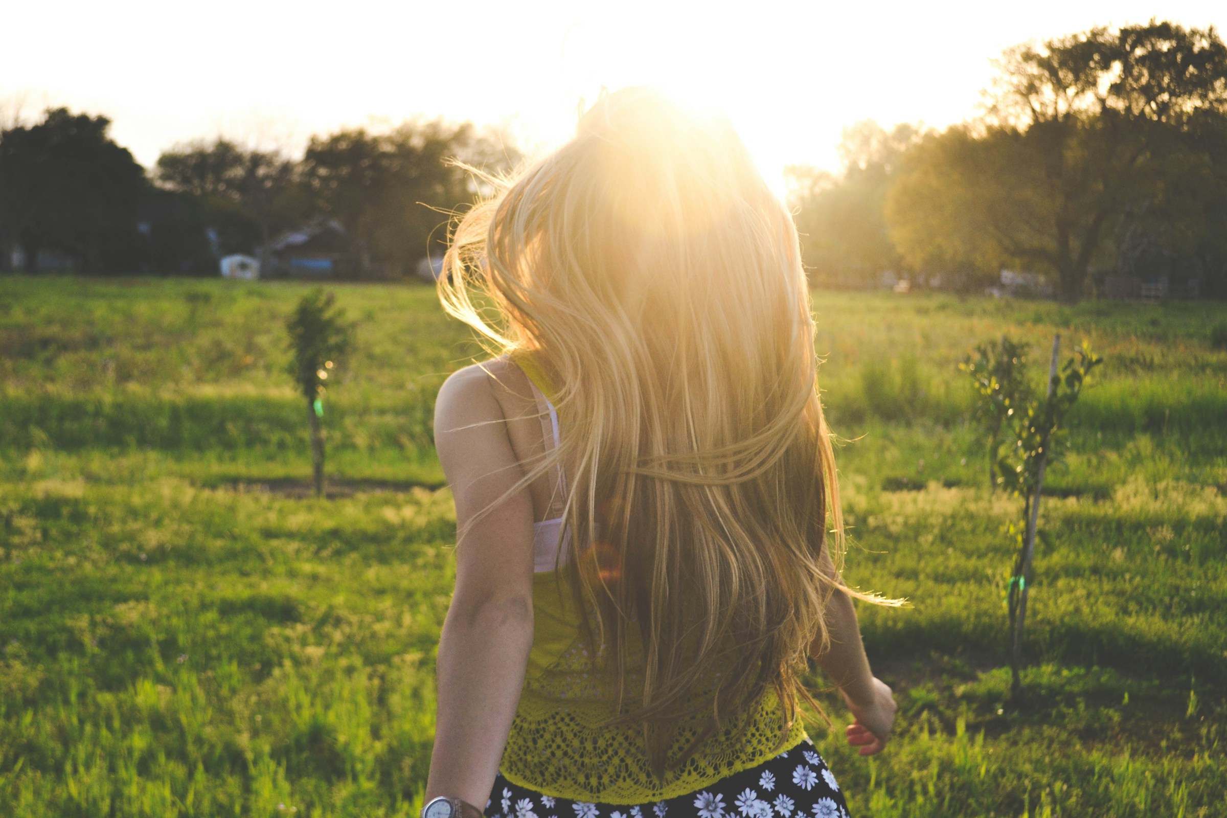 A woman running in a field during golden hour | Source: Unsplash