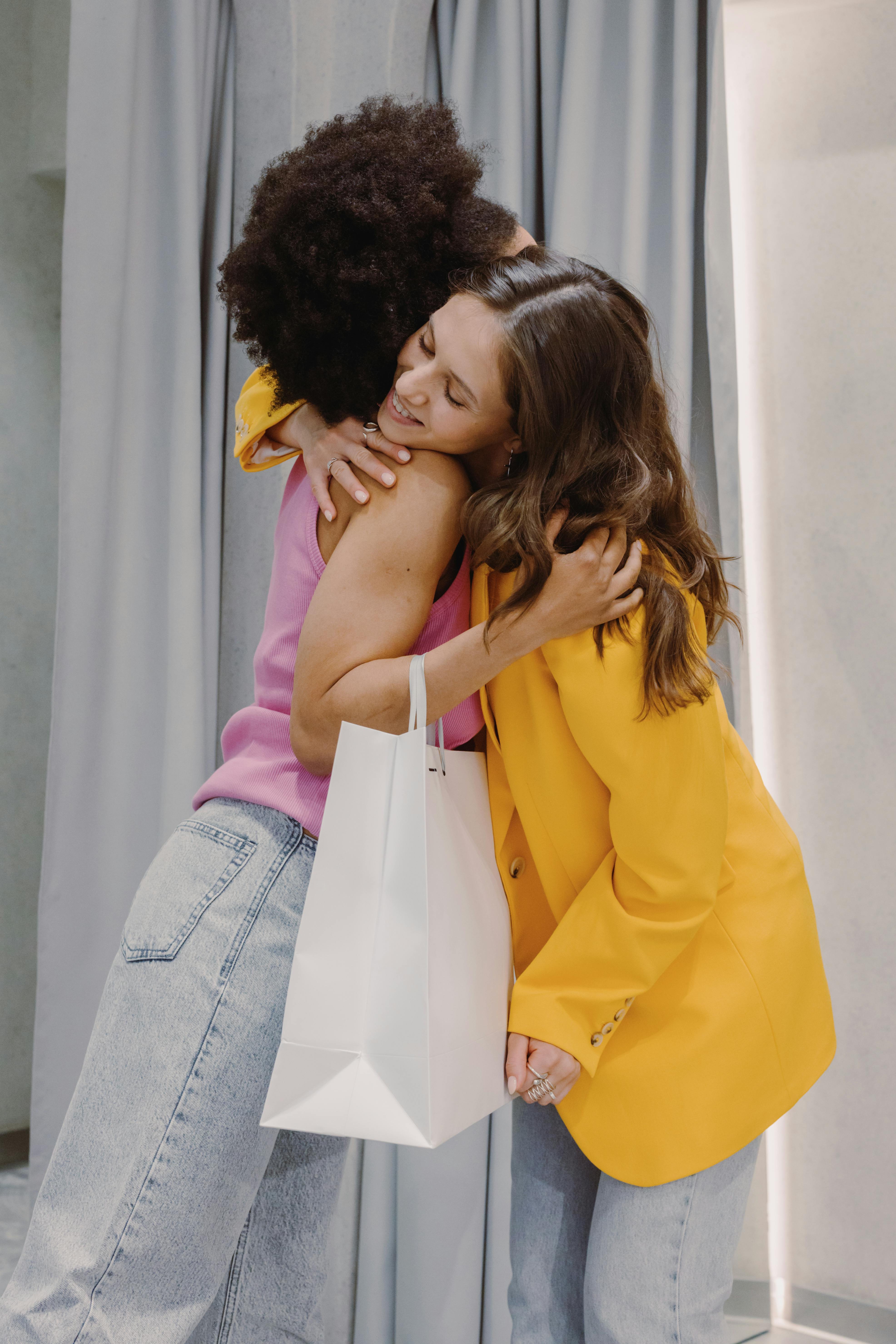 Two female friends sharing a hug | Source: Pexels