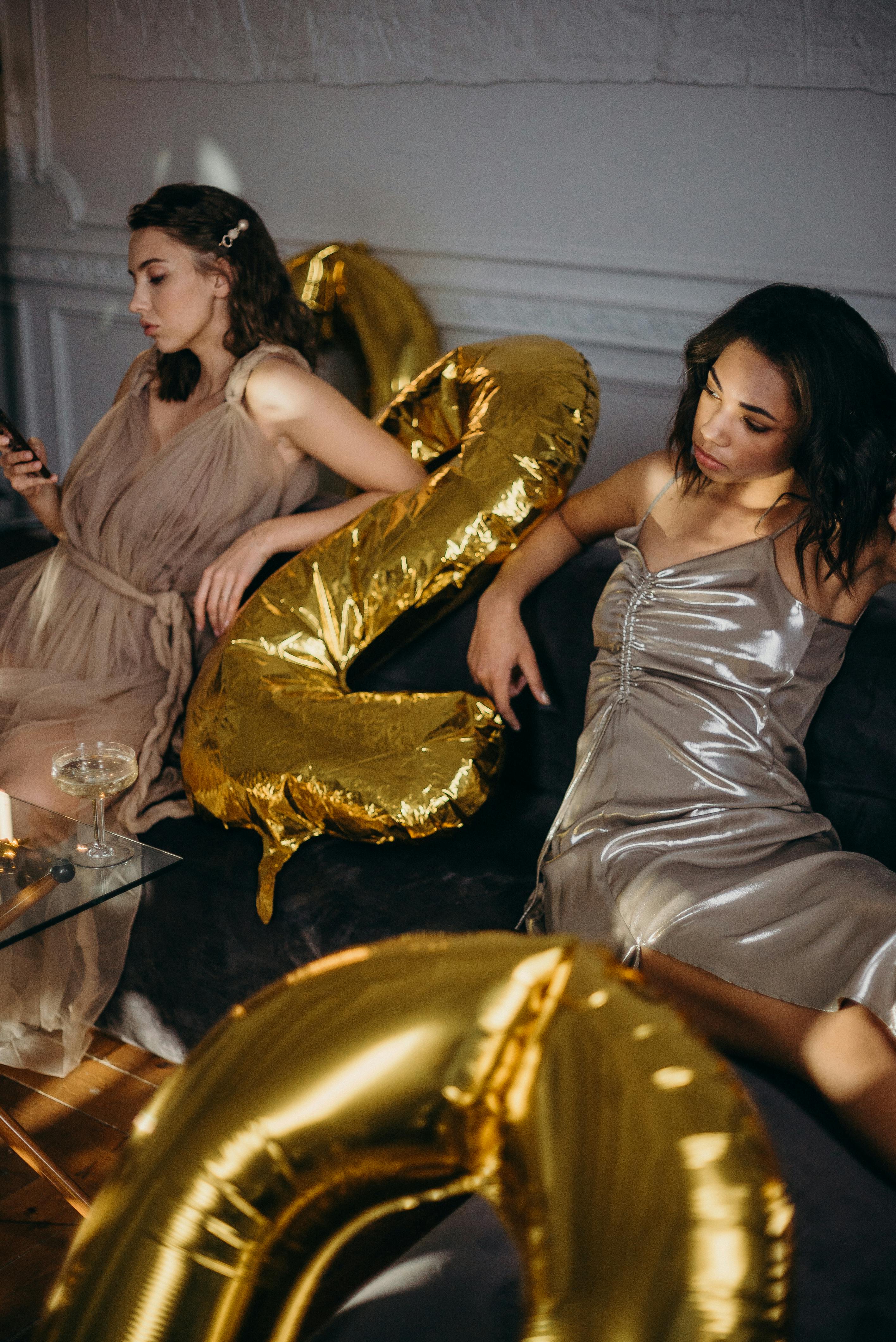 Two women sitting on a sofa | Source: Pexels